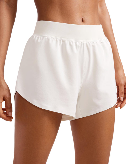 CRZ YOGA Mid Waisted Dolphin Athletic Shorts for Women Lightweight High Split Gym Workout Shorts with Liner Quick Dry Milky White (Bone) Small